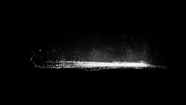 Blasting on ground, stone fragments and smoke exploded from right side flying out to the left