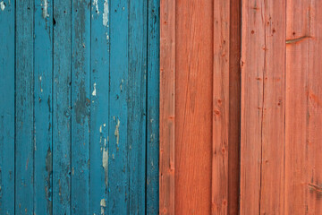 material texture of weathered wood boards with peeling red paint