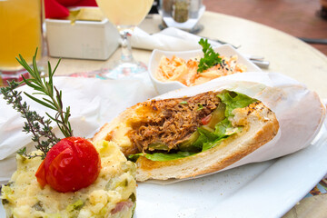 Delicious pulled pork sandwich with potato puree and coleslaw salad