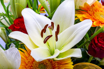 A beautiful bouquet of white lilies and orange gerberas