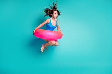 Full length body size view of her she attractive funky sporty girl jumping wearing pink safety buoy active life resort diving under aqua water isolated bright vivid shine vibrant blue color background