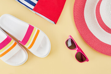 Summer background with straw beach hat, sunglasses, bag and flip flops. Summer travel concept.