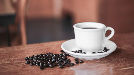 Coffee cup and saucer on a wooden table. Dark background.