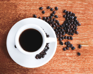 Coffee cup and saucer on a wooden table. Dark background.