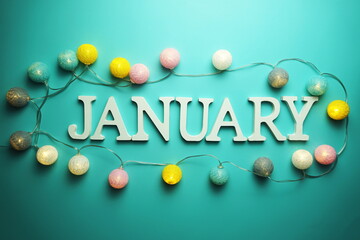 January alphabet letter with cotton ball LED decoration on blue background