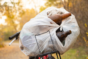 garbage bag on a bicycle in the forest in autumn, garbage collection in the forest