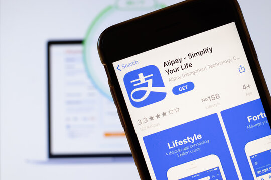 Los Angeles, California, USA - 24 March 2020: Alipay app logo on phone screen close up with website on background with icon, Illustrative Editorial