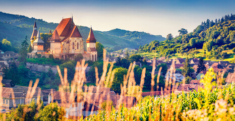 Fototapeta na wymiar Panoramic summer view of Fortified Church of Biertan, UNESCO World Heritage Sites since 1993. Spectacular morning cityscape of Biertan town, Transylvania, Romania, Europe.