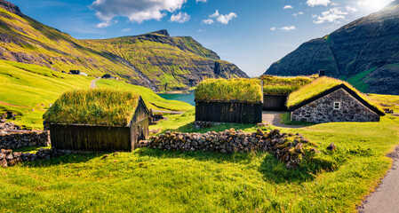 Marvelous summer view of Saksun village with typical turf-top houses and Saksunar Kirkja, Faroe...