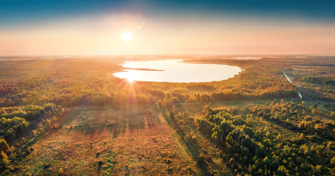 Exciting view from flying drone of Luky lake. Unbelievable summer sunrise on Shatsky National Park,  Volyn region, Ukraine, Europe. Beauty of nature concept background...