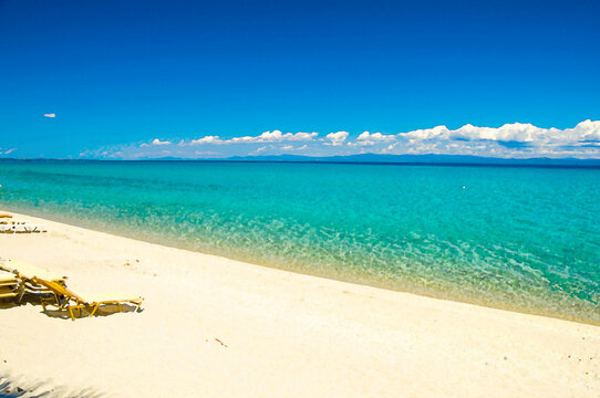 Watercolor drawing of Sandy beach with blue paradise water of Toroneos kolpos gulf, blue sky, white clouds over Sithonia peninsula in Pefkohori, Halkidiki Kassandra, Macedonia, Greece