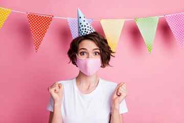 Close-up portrait of nice girl celebrating festal occasion wearing festal cap mers mask isolated pink pastel color background