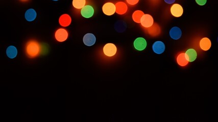 The multicolored side's or boke on a black background. Merry Christmas and happy New Year. Christmas background.