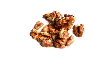 Group of chopped walnuts, peeled, pieces. Isolate on a white background. Health products. Source of magnesium, potassium, for heart health, memory will improve, antioxidants. Top view. Copy space.