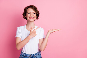 Portrait of attractive cheerful brown-haired girl holding on palm gift present surprise copy space...