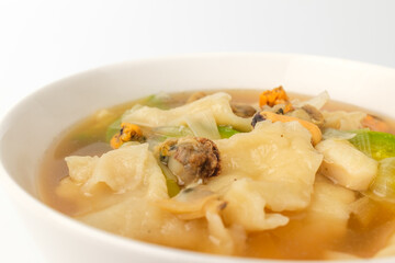 Seafood sujebi on a white background