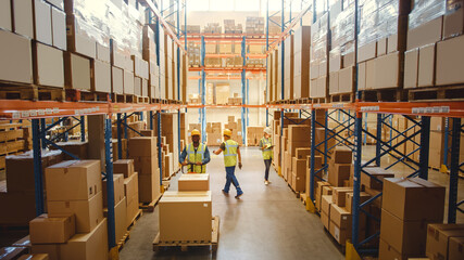 Retail Warehouse full of Shelves with Goods in Cardboard Boxes, Workers Scan and Sort Packages,...