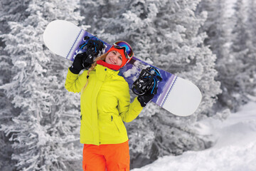 Fototapeta na wymiar Girl with snowboard on top of the mountain