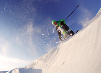 Snow Skier Jumping Against Blue Sky