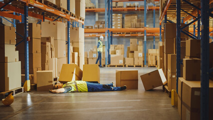 Shot of a Warehouse Worker Has Work Related Accident. He is Falling Down BeforeTrying to Pick Up...