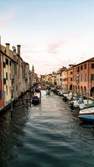 Chioggia town in venetian lagoon, water canal and church. Veneto, Italy.