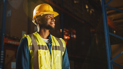 Handsome Professional Worker Wearing Safety Vest and Hard Hat Charmingly Smiling and Looks Into the...