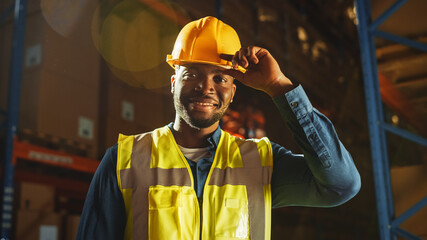 Handsome and Happy Professional Worker Wearing Safety Vest and Hard Hat Charmingly Smiling on...