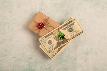 Money dollars with Christmas gift concept of spending on gifts.