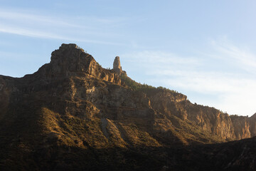 Sunset light on valley with Roque Nublo mountain on top in Gran Canaria, Spain. Natural landscape at twilight in Canary Islands. Tourist attraction destination concept