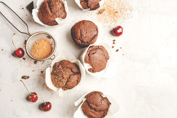 Homemade fresh chocolate muffins with berries and chocolate pieces. Top view.