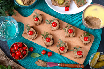 Canapes with rye bread, liver pate, cherry tomatoes. Breakfast snack. Top view.