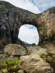 Sea arch at Pointe de Dinan on a cloudy day in summer