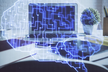 Double exposure of work space with computer and human brain drawing hologram. Brainstorm concept.