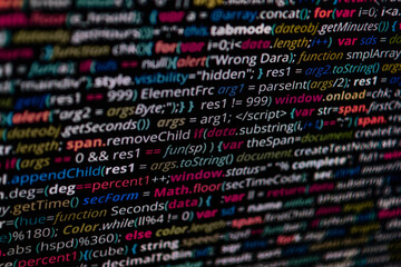 Simple website HTML code with colourful tags in browser view on dark background. White.