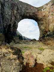 Sea arch at Pointe de Dinan on a cloudy day in summer