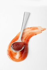 Curved swathe and spoon full of savory sauce