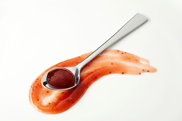 Piquant red marmalade based sauce in a silver spoon
