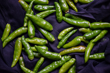 Picture of fresh and hot green chillies with black background