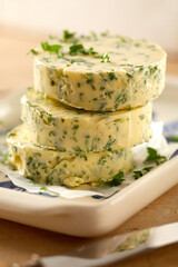Herb flavored butter pats with fresh parsley