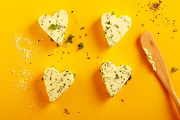 Four decorative heart shaped herbal butter pats