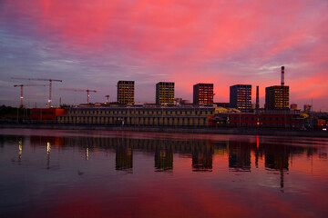 New homes are reflected in the river at dawn.