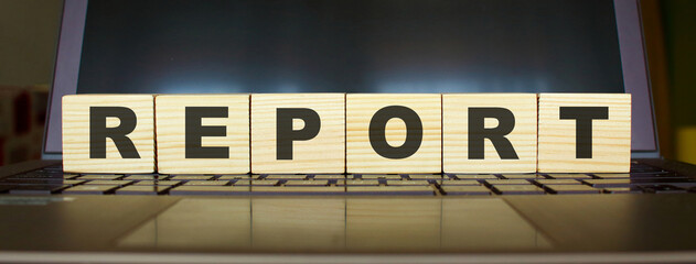 Obraz premium Wooden cubes with letters on a laptop keyboard.