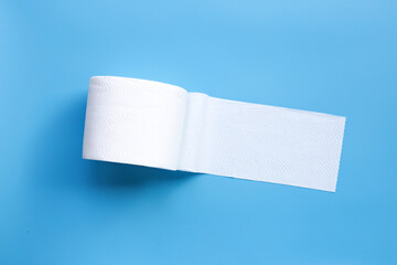 Toilet paper on blue background. Copy space