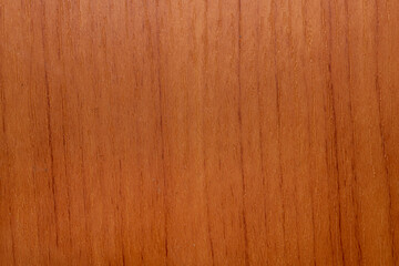 Surface of wooden floor in closeup, dark orange tone