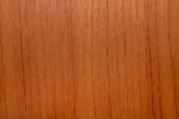 Surface of wooden floor in closeup, dark orange tone