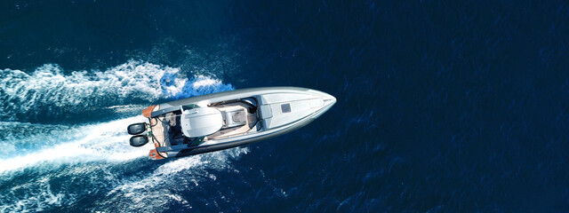 Aerial drone ultra wide photo of luxury inflatable speed boat cruising deep blue Aegean sea, Greece