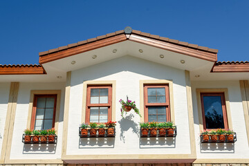 Windows with flower pots on the facade of a building in Side, Turkey