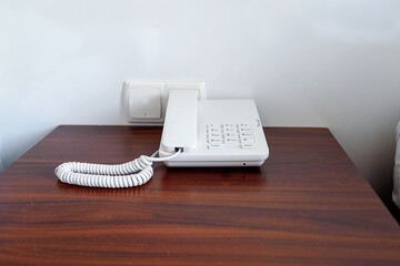 Phone on the nightstand in the hotel. The concept of a relaxing holiday.