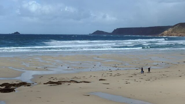 Big seas, Atlantic rollers breaking onto the beach at Sennen in Cornwall, UK. Sennen is very popular beach destination for surfing.