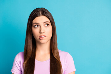Photo portrait of serious thinking woman wear casual violet outfit look empty space biting lip...